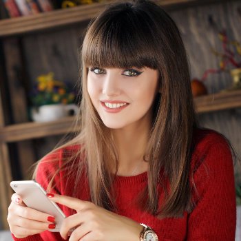 Girl reading SMS on mobile phone Dental Care   Acworth care