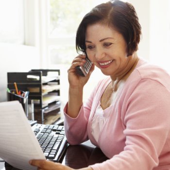 Senior Hispanic woman receptionist at Dental Care   Acworth