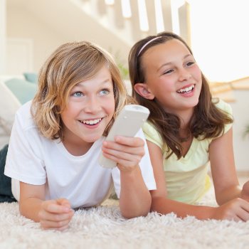 Pediatric Dentistry  Acworth siblings watching TV on floor care