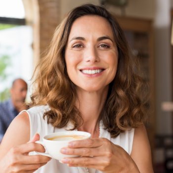 Mature woman smiling holding cup Dental Care   Acworth care